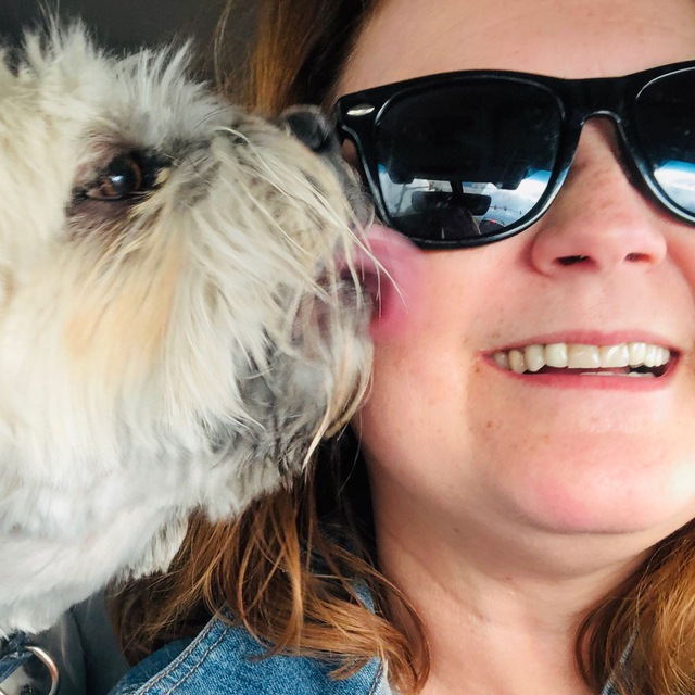Portrait of 123Stitch.com's founder with a small dog