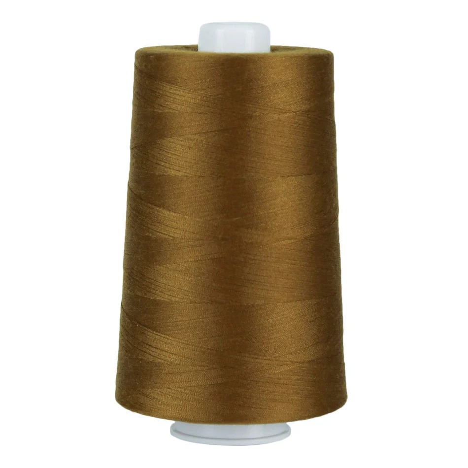OMNI Thread 6,000yds Antique Gold 3046, zoomed in. Select this picture to zoom back out.