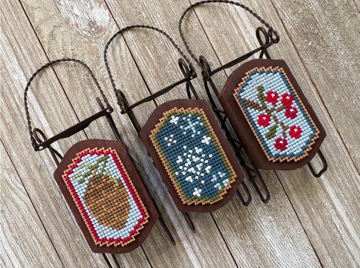 Frosty Winter Sleds - Christmas Cross Stitch Pattern, zoomed in. Select this picture to zoom back out.